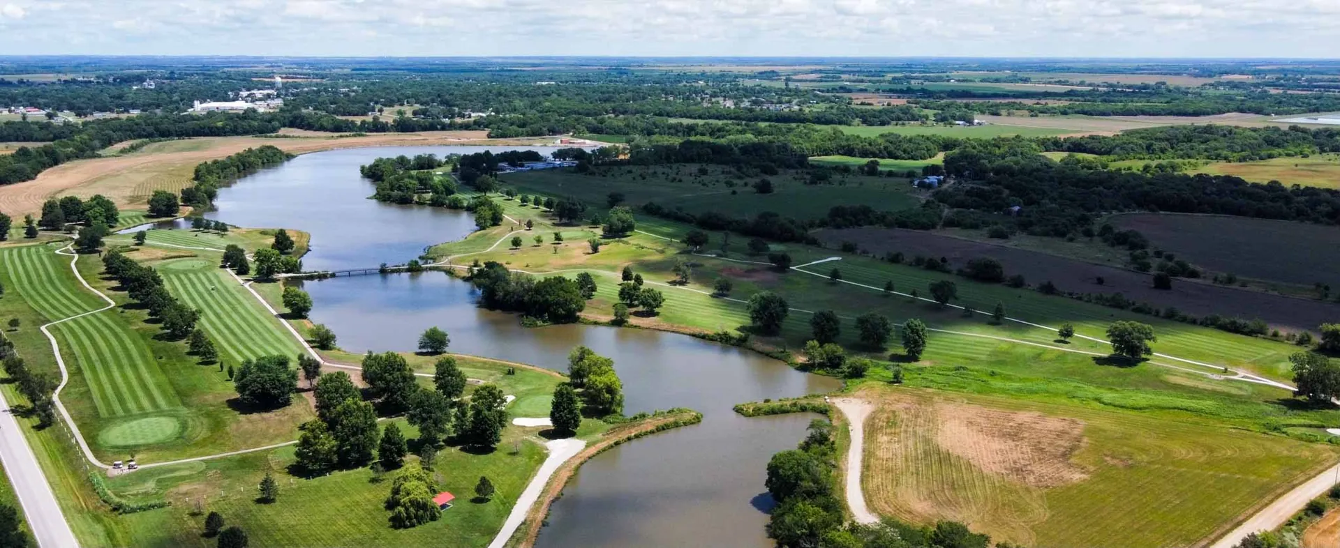 Aerial view of Osage City Golf Course and its fairways winding around Osage City Lake
